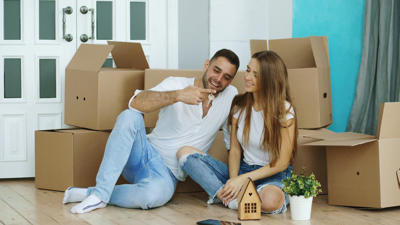 Smiling couple relaxing at home after clearing out their space
